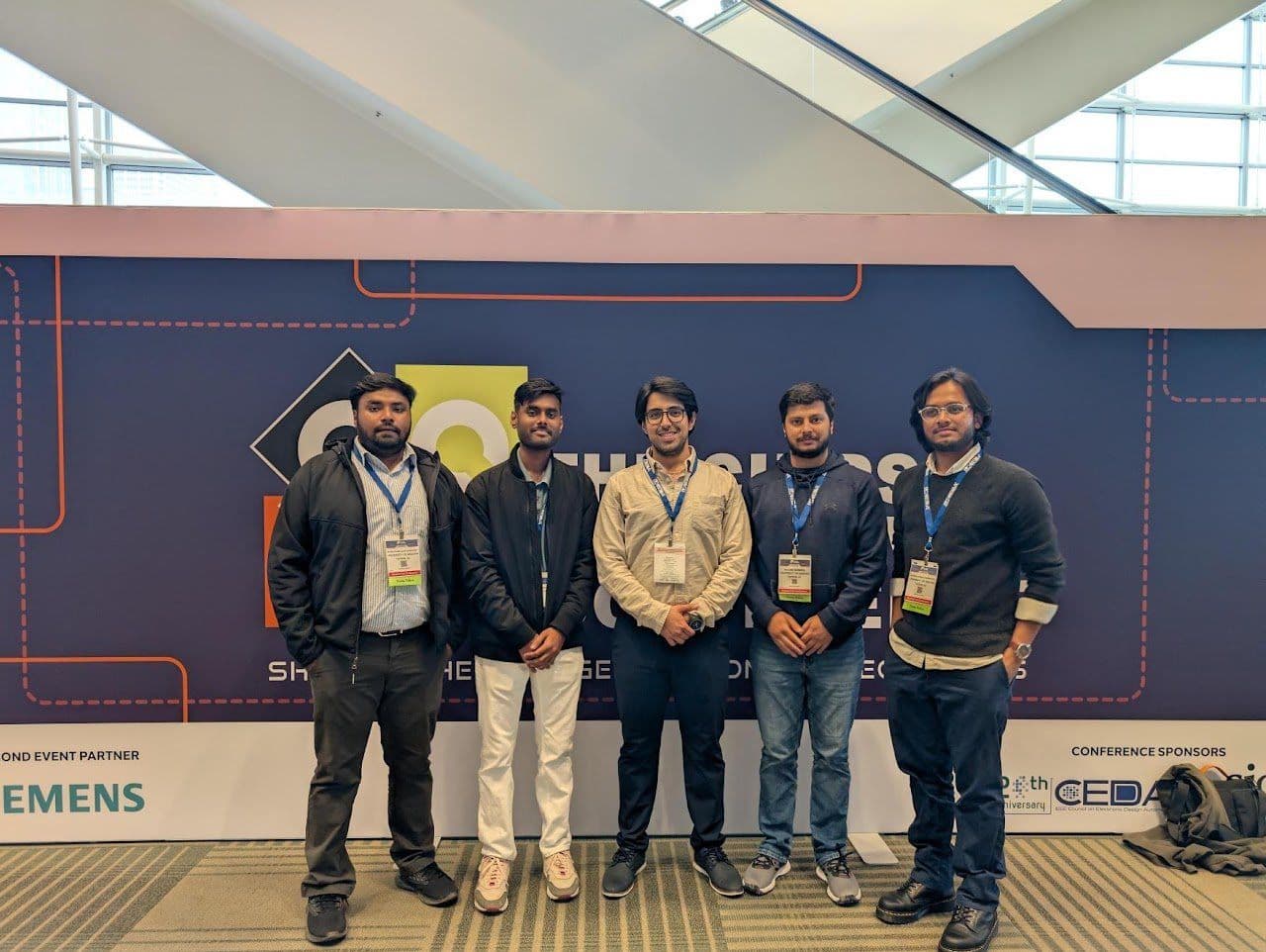 Group of DAC Young Fellows, including Sujan Ghimire, in front of a DAC 2025 banner.