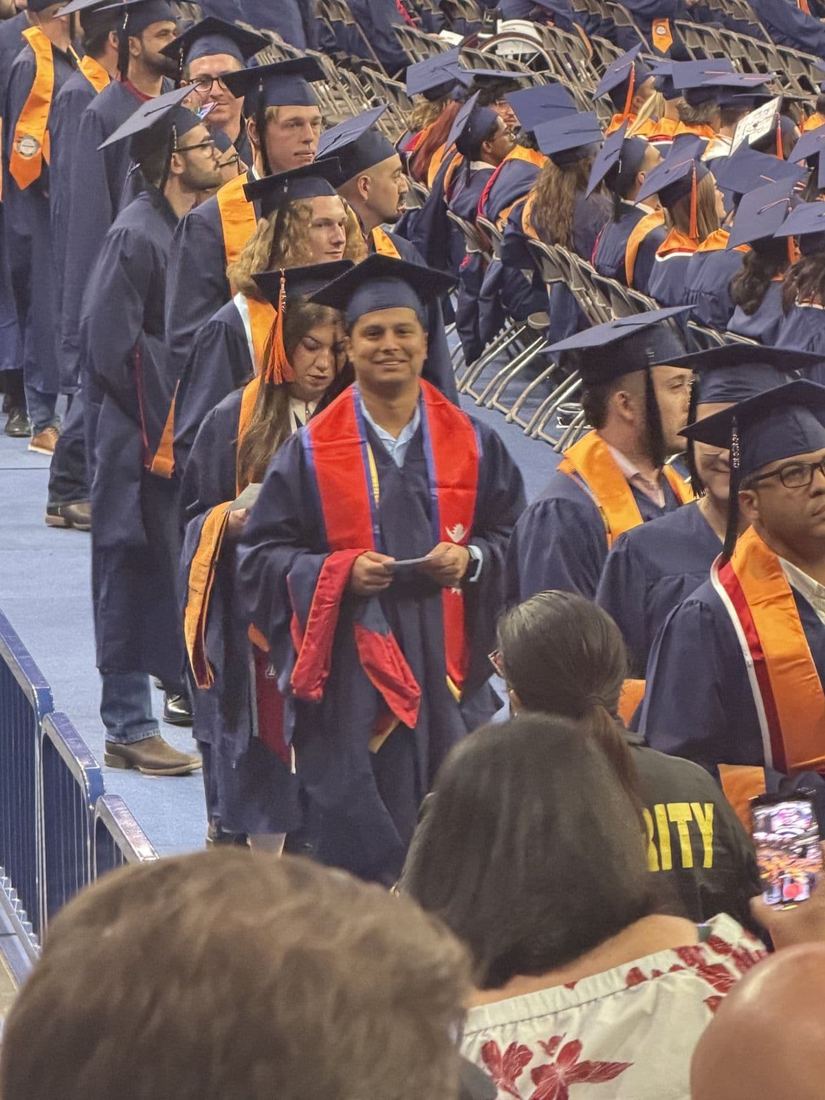 Sujan Ghimire in cap, gown, and stoles among graduates during the commencement ceremony.
